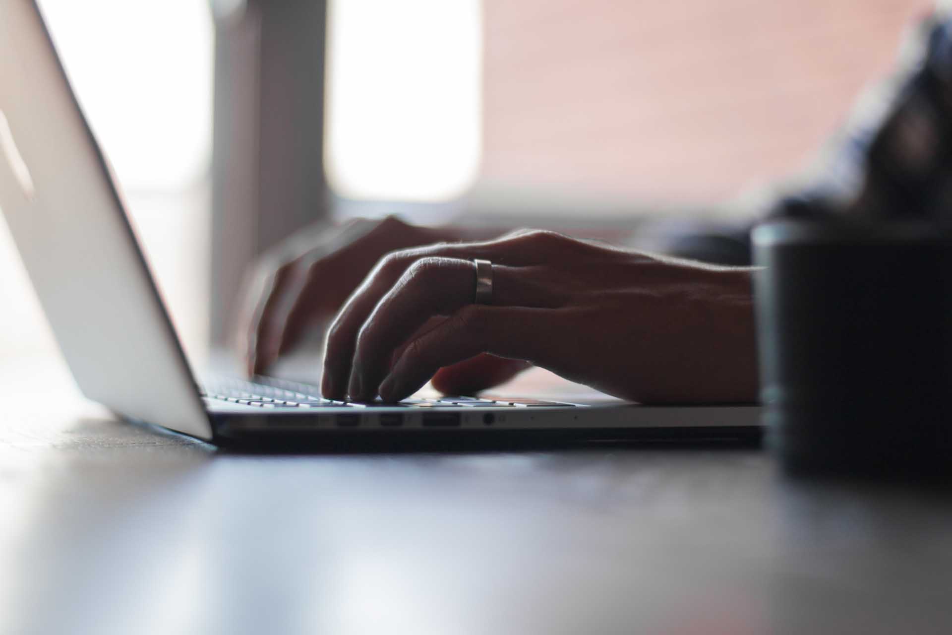 A family lawyer typing on a laptop keyboard